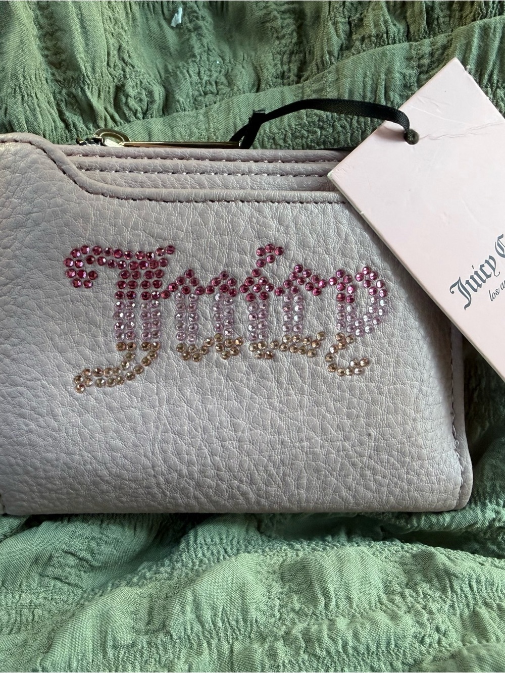 Juicy Couture White Wristlet with Pink-to-Gold Crystal Logo